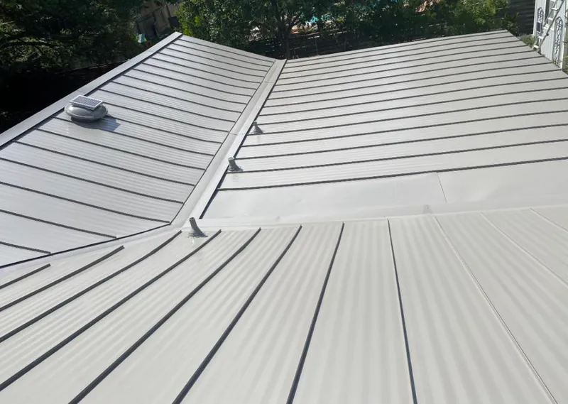 Solar attic fan installed on a metal roof for Roof Ventilation in Doney Park