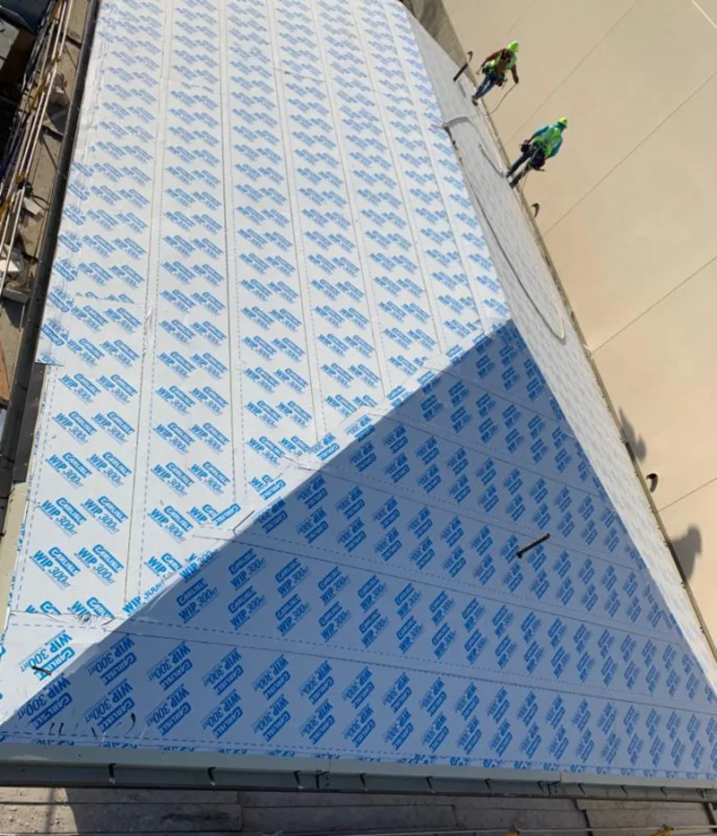 Professional roofers installing underlayment on a metal roof in Doney Park